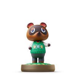 This Tom Nook Amiibo vinyl figure from Nintendo portrays the animal character with a brown face, large eyes, and pointy ears. Dressed in a green sweater featuring a diamond pattern and grey pants, it stands on a green and brown circular base. Designed for Nintendo platforms, Tom Nook has its arms slightly raised to the sides.