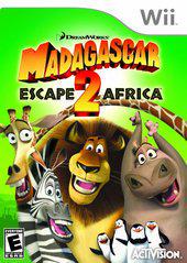 The Wii game cover for "Madagascar Escape 2 Africa" by Activision features Alex the lion, Gloria the hippo, Marty the zebra, Melman the giraffe, and zany penguins against a vibrant green African savanna backdrop. DreamWorks and Activision logos are shown. Rated E for Everyone.