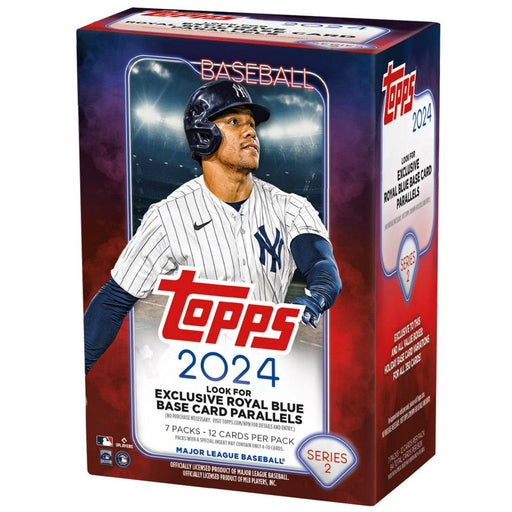 A 2024 Topps Series 2 Baseball Blaster Box featuring a player in a white and navy-blue pinstriped baseball uniform and helmet on the front. The box promotes "exclusive royal blue base card parallels" and contains 7 packs with 12 cards per pack. Officially licensed by MLB, from Topps.