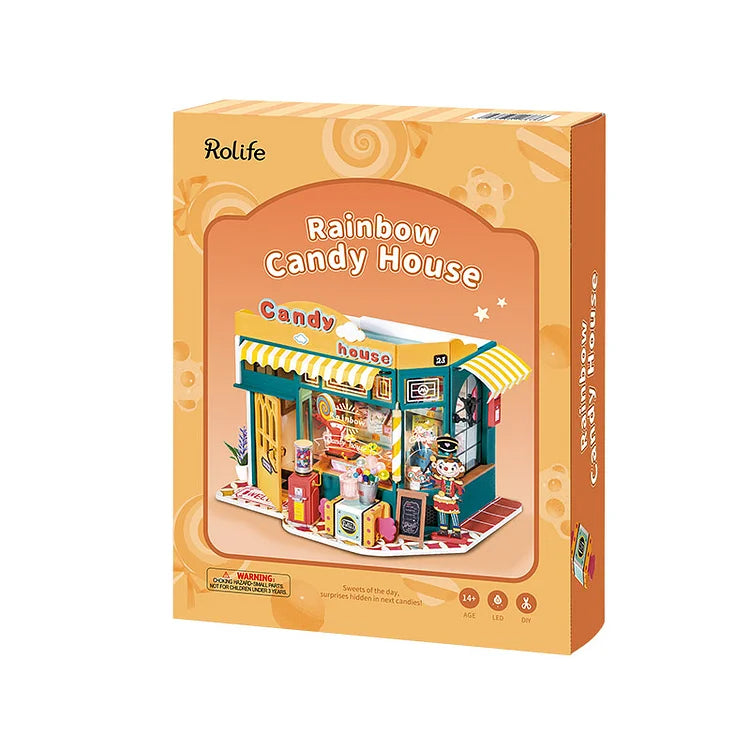 The image shows a colorful Robotime Rainbow Candy House miniature kit box. The packaging features a vibrant candy store with an awning, sweets, and a character inside on an orange background with playful patterns, highlighting the inclusion of LED lights.