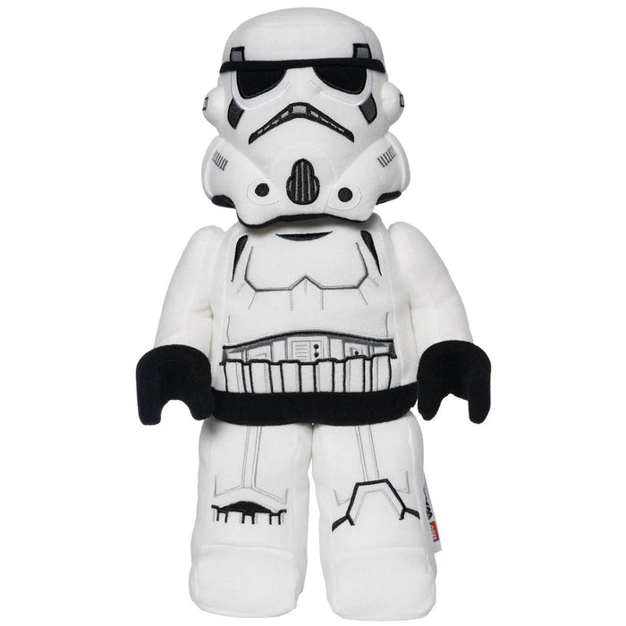 A LEGO Star Wars: Stormtrooper Plush Minifigure resembling a figure from Star Wars, this stuffed toy by Little Shop of Magic is white with black accents on the helmet, chest, and gloves, mimicking the iconic armor. It has a simplistic, cartoon-like design with soft fabric and minimal detailing, making it cute and child-friendly for any First Order fan.