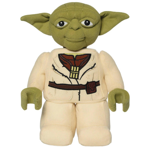 A Little Shop of Magic LEGO Star Wars: Yoda Plush Minifigure, featuring green fabric for his head and iconic pointy ears, detailed with embroidered eyes and facial features. He is wearing a tan outfit with a brown belt and robes. The toy has a soft, cushiony body and limbs.