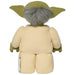 A stuffed toy resembling Yoda from Star Wars is shown from the back. The **Little Shop of Magic LEGO Star Wars: Yoda Plush Minifigure** has large green ears, gray hair, and is dressed in a beige robe. The label on the bottom of the robe is visible, displaying care instructions and other details.