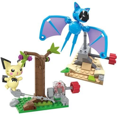 The MEGA Pokémon Adventure Builder Series 3 by Mattel includes a yellow creature with pointy ears holding a floral branch and a blue bat-like figure with wings above rocky terrain, connected via a mechanical lever on a green and brown base.