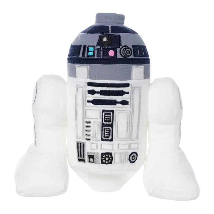 LEGO Star Wars: R2-D2 Plush Minifigure resembling the iconic Star Wars character. It features white cylindrical legs and a white cylindrical body with black, gray, and blue panels and buttons. The head is gray and blue with additional black and gray details, mimicking the original droid's design for imaginative play by Little Shop of Magic.