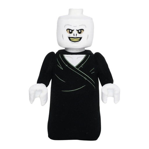 A LEGO mini-figure resembling a fictional dark wizard character from the Harry Potter books. The figure has a white, expressionless head with piercing eyes and a devious smile. Dressed in an all-black outfit with no visible legs, this ghostly figure echoes the eerie presence of Little Shop of Magic: LEGO Harry Potter: Lord Voldemort Plush Minifigure.