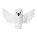 A Little Shop of Magic LEGO Harry Potter: Hedwig the Owl Plush Minifigure depicting a snowy owl with outstretched wings, reminiscent of the magical creatures from Harry Potter books. The owl is entirely white except for its yellow eyes outlined in black and a black beak. The wings are wide, giving it a lifelike appearance while remaining soft and stuffed. Light gray stitching outlines feathers on its body.