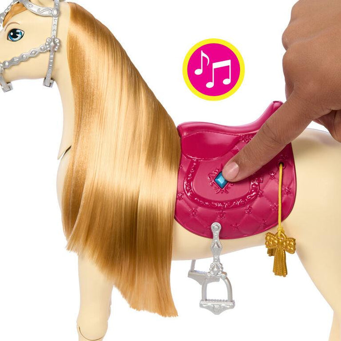 A close-up of an interactive toy horse with long, blonde hair. It features a pink saddle with a button on it. A hand is pressing the button, and a music symbol indicates the toy plays music. The **Mattel Barbie Mysteries: The Great Horse Chase Interactive Toy Horse** has silver stirrups and a golden key hanging from the saddle.
