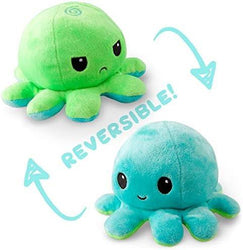 Two plush octopus toys, one green with a frown and one blue with a smile, showcasing their cute reversible plush design. The word "REVERSIBLE!" is written between them with arrows indicating the flipping motion from one octopus to the other. This Everything Games TeeTurtle Reversible Green and Aqua Octopus Plushie is trending on TikTok!