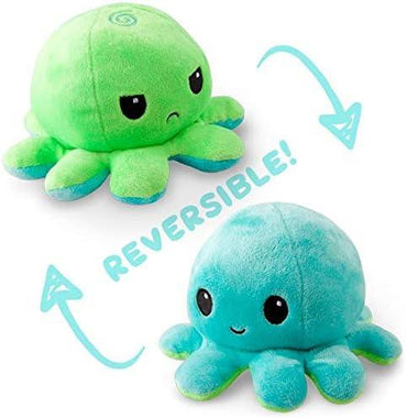 Two plush octopus toys, one green with a frown and one blue with a smile, showcasing their cute reversible plush design. The word "REVERSIBLE!" is written between them with arrows indicating the flipping motion from one octopus to the other. This Everything Games TeeTurtle Reversible Green and Aqua Octopus Plushie is trending on TikTok!