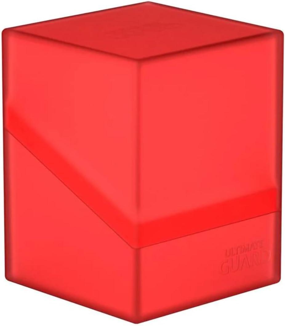 The UG Boulder 100+ Ruby by Ultimate Guard is a semi-transparent red rectangular storage case with slightly rounded edges. The durable box consists of two parts, a lid and a base, with a diagonal cut separating them for secure closure. The brand name 