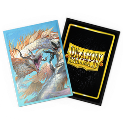 A vibrant card on the left showcases an ice dragon with icy blue scales and fierce eyes, breathing frost. On the right, another card features the Arcane Tinmen "Dragon Shield" logo on a reflective black and gold background, hinting at their protective trading sleeves. Both are slightly tilted.