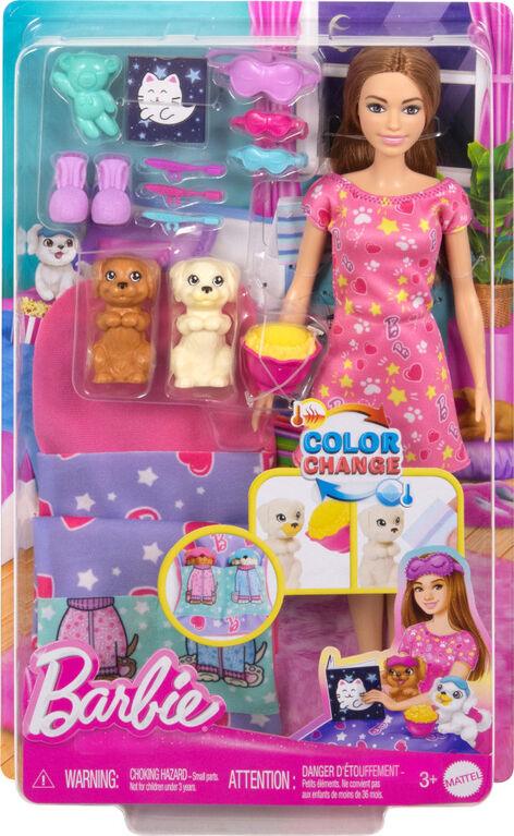 The image shows a Mattel Barbie-Slumber Party Puppies-Doll Set in its packaging. The Barbie doll with puppies has long brown hair and wears a pink dress with various colorful shapes. The set includes a white and a brown dog, dog accessories, and a toy washing machine. The packaging highlights the color-changing puppy muzzle feature when washed.