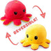 Two super soft, reversible octopus plushies with a unique design. One side is red with an angry face; the other side is yellow with a happy face. Red arrows highlight the reversible feature, and "REVERSIBLE!" is prominently displayed in the center between these Everything Games TeeTurtle Reversible Red and Yellow Octopus Plushie mood plush toys.