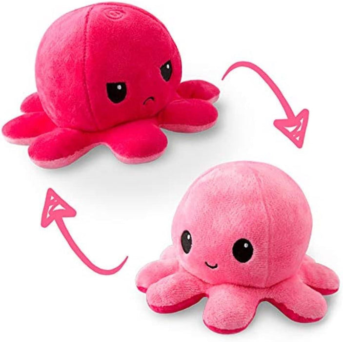 Two cute Teeturtle Reversible Light Pink and Dark Pink Octopus Plushies are shown, one above the other. The top octopus is bright pink with an angry face, having downturned eyes and mouth. An arrow curves to the bottom octopus, which is light pink with a happy face, featuring upturned eyes and a small smile.