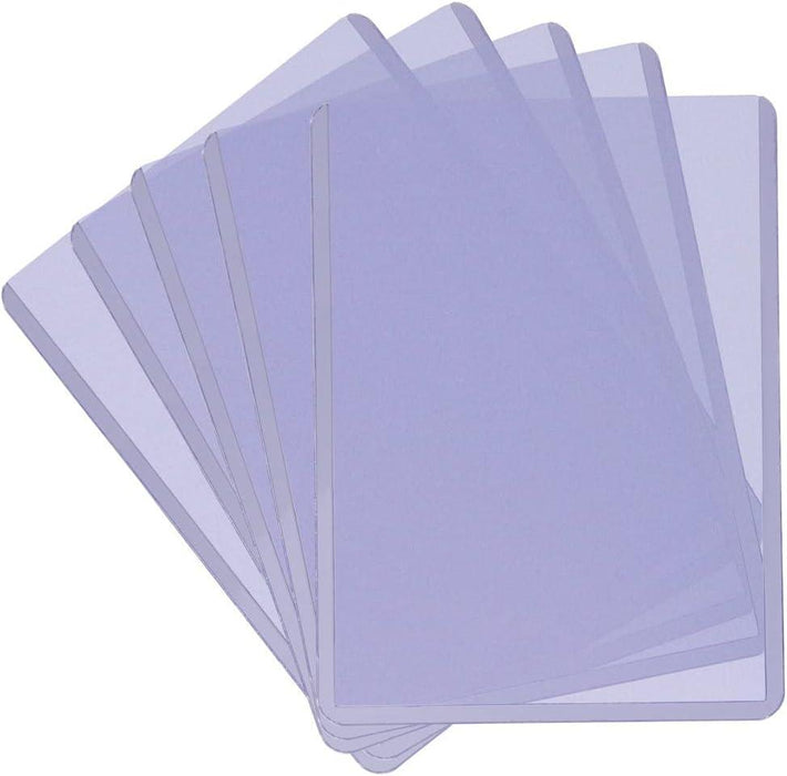 A set of six translucent trading card protectors spread out in a fan-like arrangement. The sheets are uniform in size with rounded corners and have a slight purple tint, making the overlapping areas appear darker. Ideal for collectible trading cards, each Ultra PRO Ultra Pro 3" X 4" Clear Regular 25ct Top Loaders for Cards Baseball Card Protectors Hard Plastic Hard Card Sleeves Card Top Loaders is smooth and shiny.