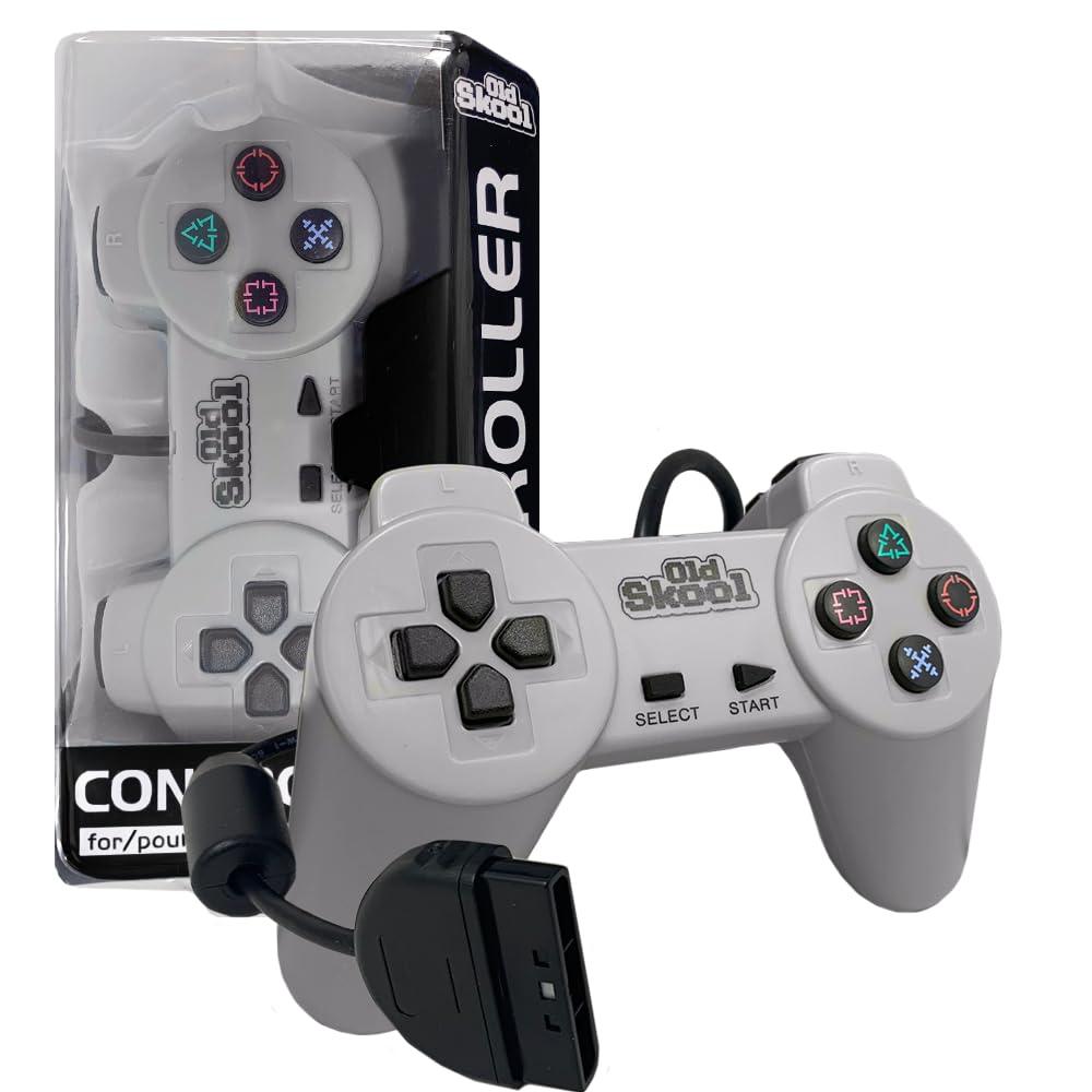 The Old Skool PlayStation 1 Wired Controller, a retro-style gray third-party gamepad with dual analog sticks and a D-pad, is showcased in front of its packaging. The "Old Skool" branding and four symbol-colored buttons are prominent. The package's partial transparency reveals the controller's profile.