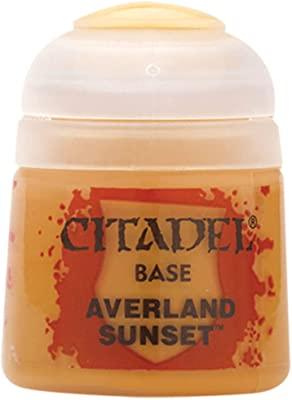 The Citadel Base - Averland Sunset is a small, round pot with a clear lid, ideal for acrylics. The label showcases the Citadel logo and color name in bold black text on a yellow-orange background with red splatters, perfect for base coating.