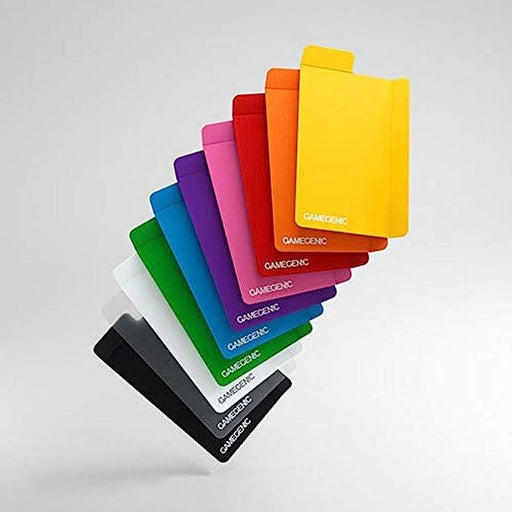 A neatly arranged fan of Game Genic Flex Card Dividers | 10-Pack of Multi-Color Card Dividers appears against a pale gray background. The vibrant, varied colors include yellow, orange, red, pink, purple, blue, green, white, and black. Each divider has the Game Genic logo prominently displayed. Consider matching them with foldable register tabs for better organization.