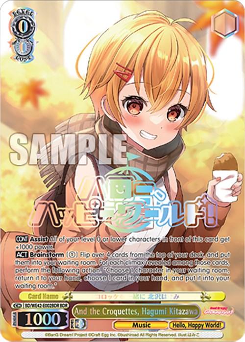The trading card features an anime girl with short orange hair and a cheerful expression. She is wearing a white apron, holding a spoon and a dish. The card, part of the Countdown Collection for BanG Dream! Girls Band Party!, is labeled "And the Croquettes, Hagumi Kitazawa (BD/WE42-E002BDR BDR) [BanG Dream! Girls Band Party! Countdown Collection]." It has various text boxes detailing card statistics and effects, along with colorful graphics. This product is brought to you by Bushiroad.
