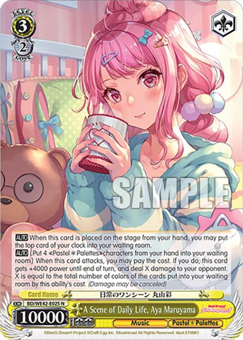 A Bushiroad trading card from the Countdown Collection features Aya Maruyama from the game BanG Dream! Girls Band Party!. A Scene of Daily Life, Aya Maruyama (BD/WE42-E025 N) [BanG Dream! Girls Band Party! Countdown Collection], a member of Pastel Palettes, has pink hair and a cheerful expression while holding a drink. The card details, stats, and abilities are visible, with various colors and symbols enhancing its aesthetic.