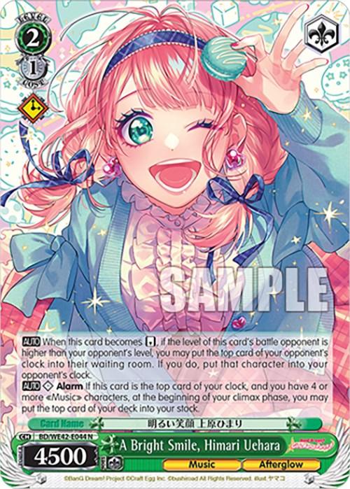 A colorful trading card from the BanG Dream! Girls Band Party! Countdown Collection by Bushiroad featuring an anime girl with pink hair, a ribbon, and a cheerful expression. She is holding one arm up. The card has various stats and text, including "A Bright Smile, Himari Uehara (BD/WE42-E044 N)," with 4500 power. The background is vibrant with musical notes and decorative elements.