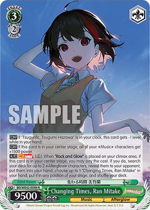 A trading card from the game BanG Dream! Girls Band Party! featuring the character Ran Mitake. She is shown smiling with one hand raised. The card's name is "Changing Times, Ran Mitake (BD/WE42-E049 N) [BanG Dream! Girls Band Party! Countdown Collection]" with stats of 3 cost and 2 soul, 9500 power. Part of the Countdown Collection, it features a "SAMPLE" watermark over the card. This product is by Bushiroad.
