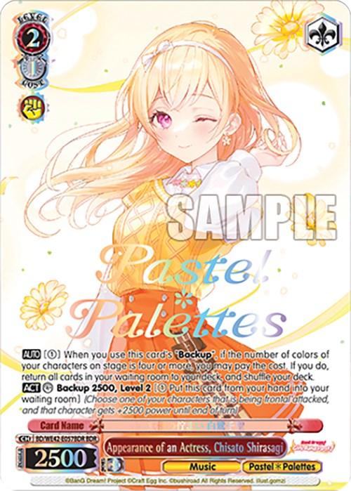 A trading card features an anime-style illustration of a blonde girl in a yellow dress, smiling warmly with one hand raised. Titled "Appearance of an Actress, Chisato Shirasagi (BD/WE42-E057BDR BDR) [BanG Dream! Girls Band Party! Countdown Collection]," it's part of the Bushiroad collection. Game stats like "Level 2" and "Power 2500" are at the top left.