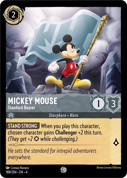 A Disney Lorcana trading card features Mickey Mouse in heroic attire holding a staff in front of a blue flag. The card details include "MICKEY MOUSE, Standard Bearer," with attributes 1 attack and 3 defense. The effect, "STAND STRONG," grants Challenger +2. The flavor text reads, "He sets the standard for intrepid adventurers everywhere." This particular product is named Mickey Mouse - Standard Bearer (188/204) [Ursula's Return].