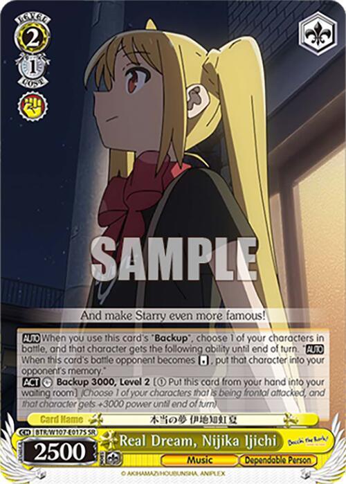 Image of a Super Rare trading card featuring an anime character with long blonde hair, wearing a black outfit with a red bow tie. Text on the card reads “Real Dream, Nijika Ijichi (BTR/W107-E017S SR) [BOCCHI THE ROCK!]” from Bushiroad and includes game statistics: level 2, cost 1, power 2500. The background depicts a cityscape at dusk.
