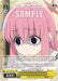 A trading card features an anime-style character with long pink hair and big blue eyes, appearing nervous. The character wears a blue shirt. Various game stats and abilities are listed on the character card, which includes text and icons. Titled "Forgotten Cuteness, Hitori Gotoh (BTR/W107-E028 C) [BOCCHI THE ROCK!]" from Bushiroad, it boasts a power level of 4000 and level 1.