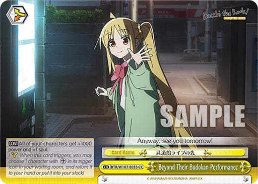 A Bushiroad trading card features an anime girl with long blonde hair in twin tails, wearing a white shirt with a red bow and a dark skirt. She waves with a smile, standing on a quiet city street at night. The card, inspired by "Bocchi the Rock," is titled "Beyond Their Budokan Performance (BTR/W107-E033 CC) [BOCCHI THE ROCK!]" and has game details written on it.