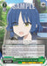 The image features a collectible trading card from BOCCHI THE ROCK titled "Converting Bass to Cash, Ryo Yamada (BTR/W107-E044 R) [BOCCHI THE ROCK!]." This rare character card from Bushiroad depicts an anime-style character with blue hair and green eyes, speaking with an open mouth. The 2024 release card boasts various icons, stats, effects, and textual descriptions.