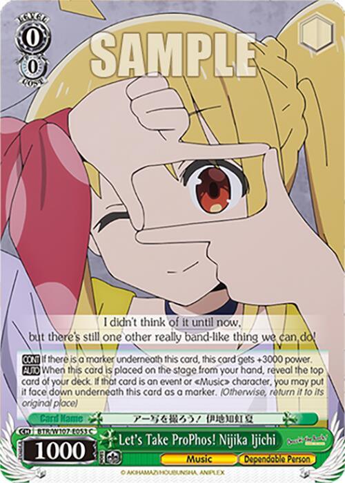 A character card featuring a colorful anime-style illustration from "Bocchi The Rock." A character with long blonde hair and expressive yellow and red eyes holds their hands in a rectangle frame gesture towards the viewer. The card text reads "Let's Take ProPhos! Nijika Ijichi (BTR/W107-E053 C) [BOCCHI THE ROCK!]," highlighting her music traits. This product is brought to you by Bushiroad.