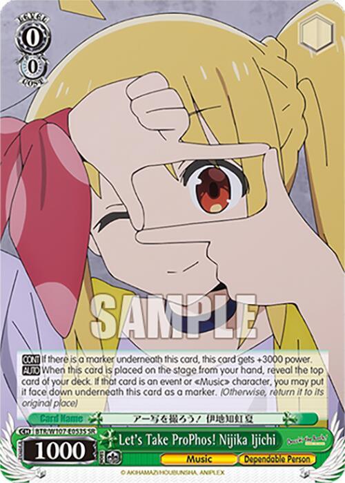 A super rare trading card featuring a music character from BOCCHI THE ROCK! depicts Nijika Ijichi forming a rectangle with her fingers over her right eye while winking. She has long blonde hair tied in a pink ribbon and wears a yellow vest over a white shirt. The card title reads "Let's Take ProPhos! Nijika Ijichi (BTR/W107-E053S SR) [BOCCHI THE ROCK!] by Bushiroad.