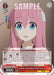 A trading card features an animated girl with long pink hair and blue eyes, wearing a white shirt with blue straps. Text on the card includes her dialogue, "Wh-What do I do?" and details about the card’s abilities and stats. The card name is "Avoiding a Development, Hitori Gotoh (BTR/W107-E090 C) [BOCCHI THE ROCK!]" from Bushiroad.