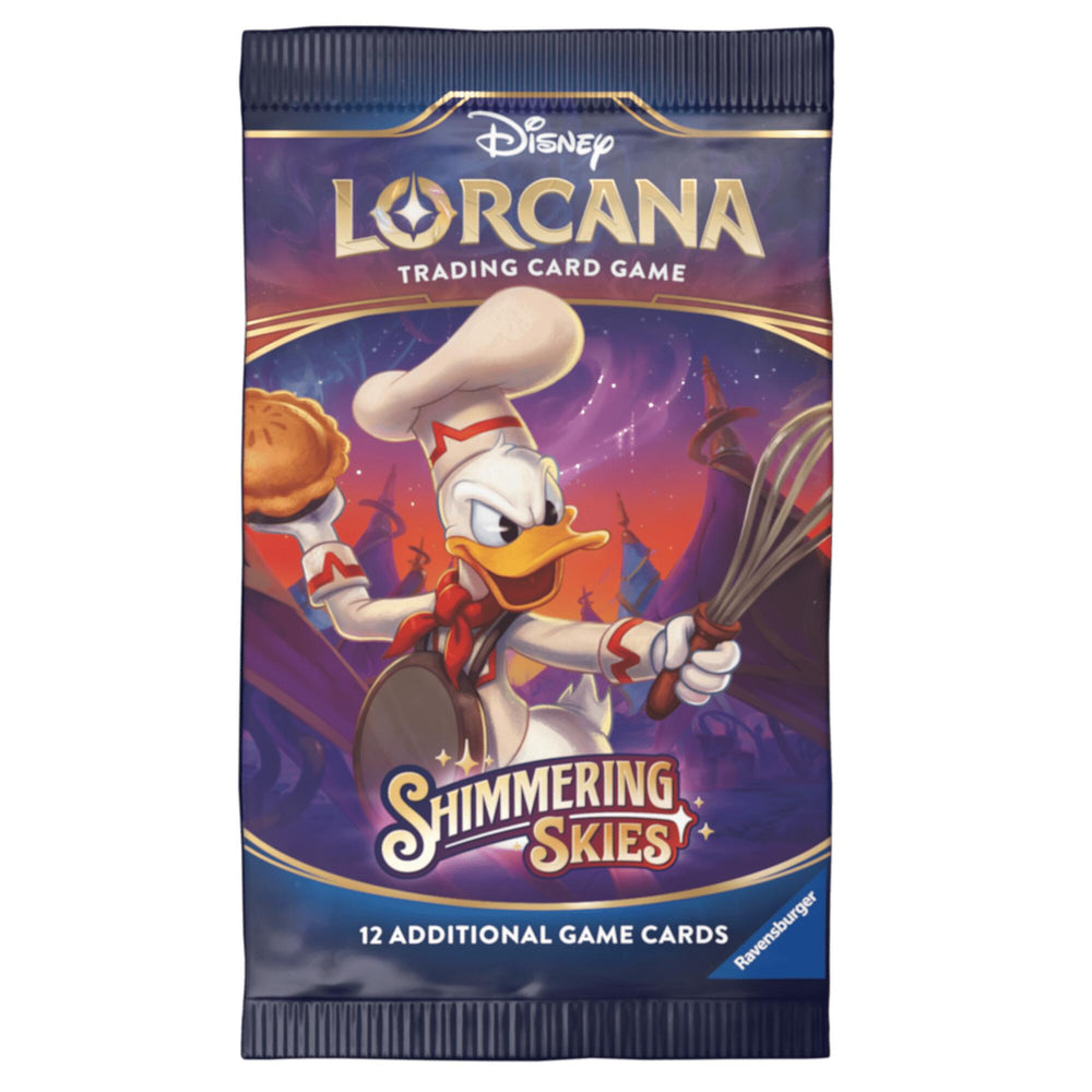 A Disney Lorcana: Shimmering Skies Booster Pack showcases an illustration of Donald Duck dressed as a chef, holding a pie in one hand and a whisk in the other, set against a mystical landscape. The pack, sealed in a blue wrapper, contains 12 additional game cards.