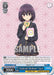 A Super Rare trading card named "Ayakashi Medium" Suzu from Bushiroad's Ayakashi Triangle series features an anime girl in a dark school uniform, holding a small, colorful paper charm. She has short purple hair and pink eyes, standing against a geometric pink background. The Character Card details include a cost of 0, power of 2000, and various game mechanics text.