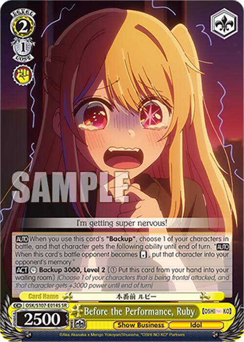 The Super Rare Card called "Before the Performance, Ruby (OSK/S107-E014S SR) from OSHI NO KO by Bushiroad features an animated character with long blonde hair and red streaks. She appears anxious, with wide eyes and a small frown. Boasting 2500 power, the card includes details about its backup ability. At the bottom, it reads "Show Business" and "Idol.