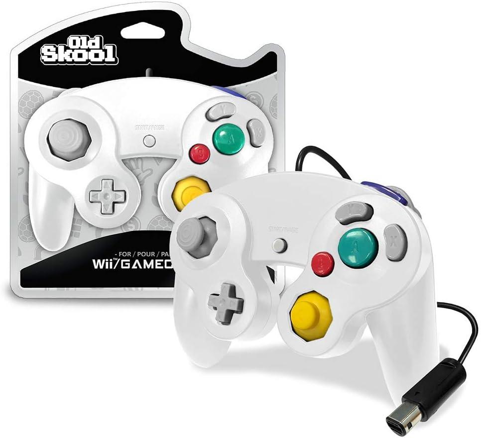 Two Old Skool white Gamecube/Wii controllers with colorful buttons are displayed, one in packaging and one unboxed. The unboxed controller features a joystick, a yellow C-stick, red, blue, and green pressure-sensitive buttons, and is attached via a black cable.