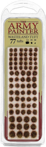 The image displays a pack of Army Painter's Battlefield Tufts: Wasteland Tuft, ideal for basing painted miniatures. It includes 77 tufts in three sizes (12 large, 35 medium, 30 small) resembling brown grass or shrubs on a yellow card in clear plastic packaging.