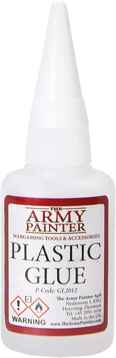 A plastic glue bottle from the Army Painter brand. The bottle is white with a red and cream-colored label reading "The Amy Painter Plastic Glue" and featuring a warning symbol. Specially formulated as polystyrene cement, it creates a strong bond ideal for plastic miniatures. Additional details are printed at the bottom.