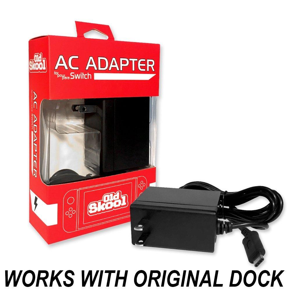 The image shows an Old Skool AC Adapter for the Nintendo Switch gaming console. The adapter is packaged in a red and white box with a clear plastic window displaying the product. The text on the packaging reads 