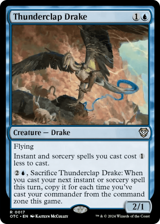 The Thunderclap Drake [Outlaws of Thunder Junction Commander] card from Magic: The Gathering showcases a flying drake with large wings wielding a lightning bolt in one claw. Against a rocky terrain and stormy skies backdrop, the card boasts blue borders, Kaitlyn McCulley's illustration, and game details at the bottom.