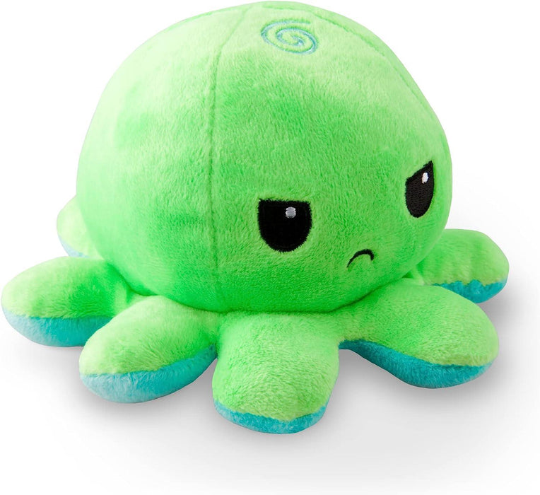 A TeeTurtle Reversible Green and Aqua Octopus Plushie by Everything Games is shown. It is light green with eight short tentacles that have blue tips. The toy has large, black eyes with white reflections and a small, frowning mouth. A spiral design is visible on top of its head, giving it a slight whimsical touch. Ideal for TikTok!