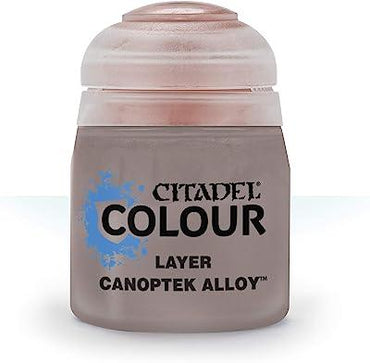 A transparent Citadel pot containing "Layer Canoptek Alloy" features metallic paint for miniatures, a rounded clear lid, and a label with a blue splash design beside the "Colour" text. Ideal for edge highlighting.