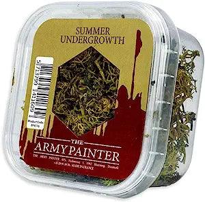 The Army Painter Battlefield: Summer Undergrowth, a product from the renowned Army Painter brand, is a clear plastic container filled with basing material that provides a super realistic appearance. It contains dried, moss-like grass perfect for model landscaping. The container sports a red and brown design and includes a hexagonal window for viewing the contents, alongside a barcode on the side.