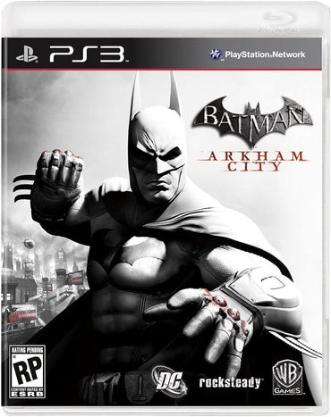 The cover image for "Batman Arkham City" shows Batman poised dramatically against a monochrome cityscape backdrop, with the title prominently in bold. Logos for DC Comics, Rocksteady, and WB Games are displayed at the bottom. Rating is pending.