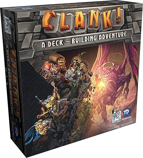 The image shows the box cover of "Clank!" by Dire Wolf Digital. Four adventurers climb rocks toward a dragon's mountain lair in this deck-building board game. The bold title "Clank!" enhances the fantasy dungeon delving experience.