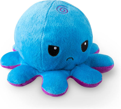 A TeeTurtle Reversible Blue and Purple Octopus Plushie by Everything Games shaped like an octopus with a smooth, blue body and eight limbs. The toy has a small spiral design on top and features a sad expression with downturned eyebrows and a frowning mouth. The underside of the limbs is purple. This reversible octopus plushie is set against a white background.